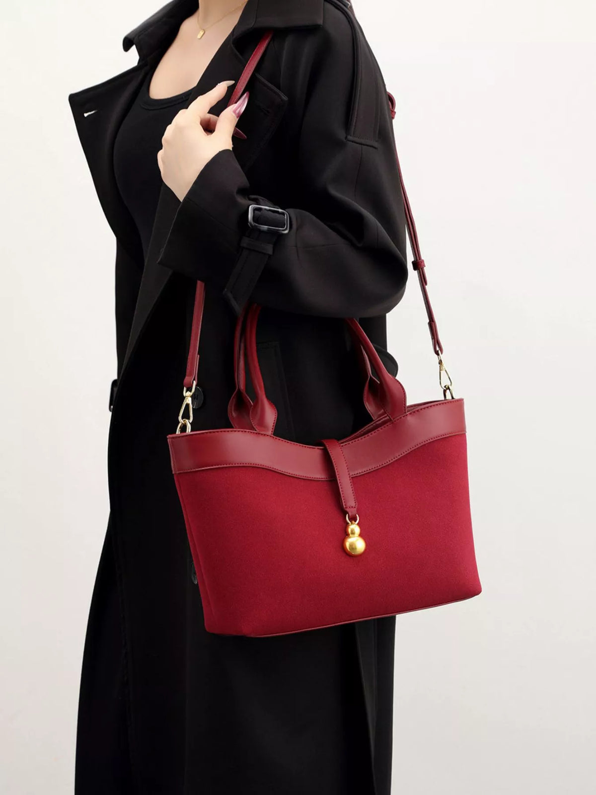 Wine red crossbody bag with a gold charm